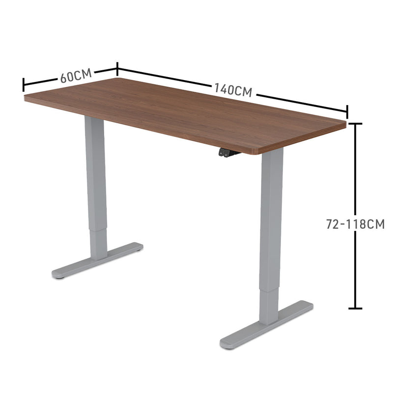 Fortia Sit To Stand Up Standing Desk, 140x60cm, 72-118cm Electric Height Adjustable, 70kg Load, Walnut Style/Silver Frame